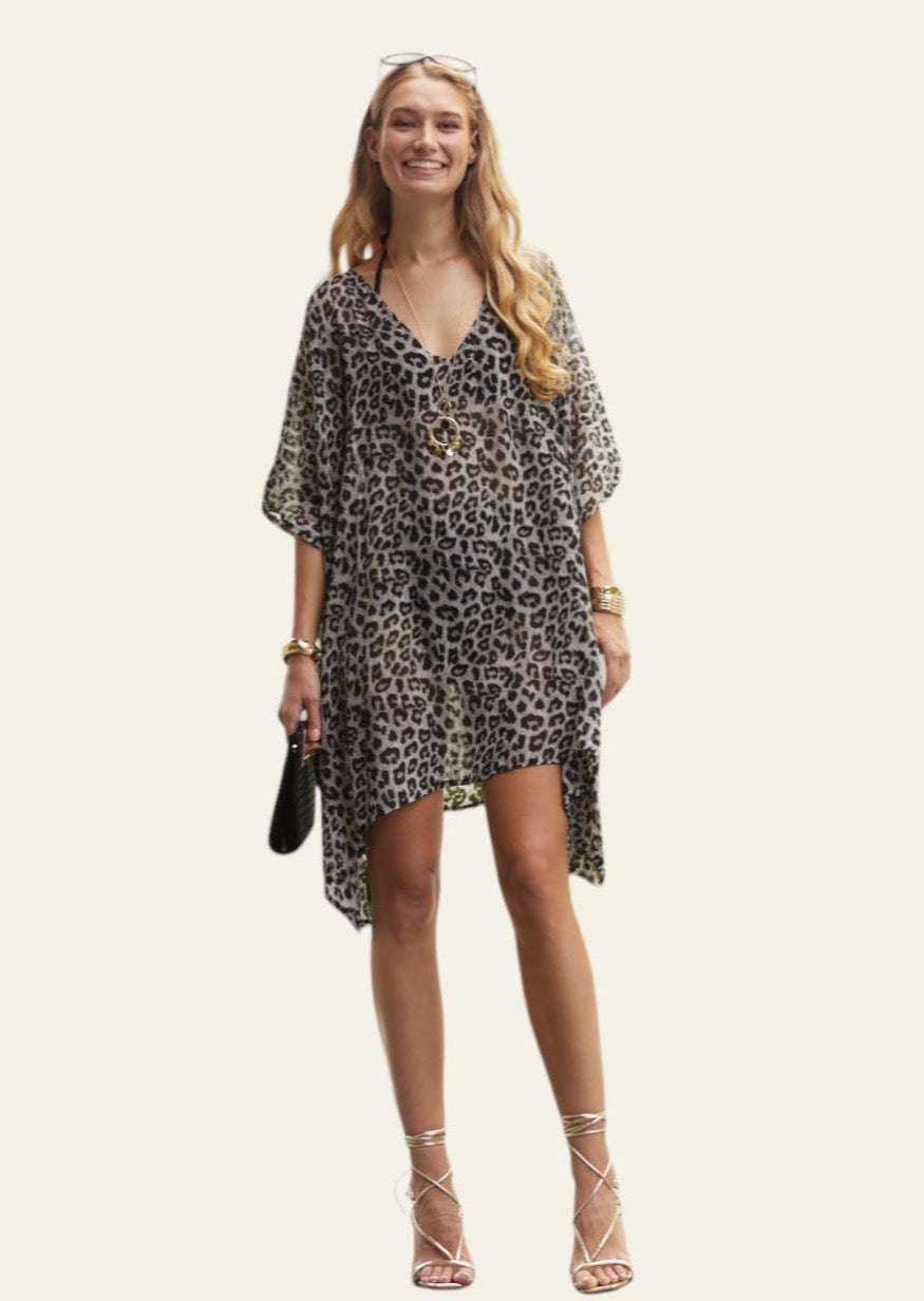 This lightweight animal print cover-up is designed for the beach, offering a relaxed and stylish layer over swimwear. The fabric is soft and breathable, making it ideal for warm weather. The cover-up reaches just above the knees, providing enough coverage while still being breezy and comfortable.